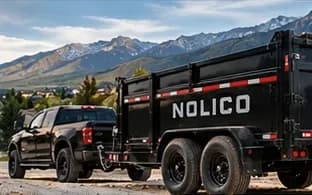 NOLICO dump trailer and pickup parked at a new-home job site